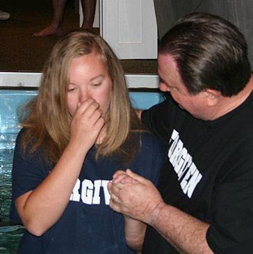 Mackenzie Luck is baptized by Rich Hodgman